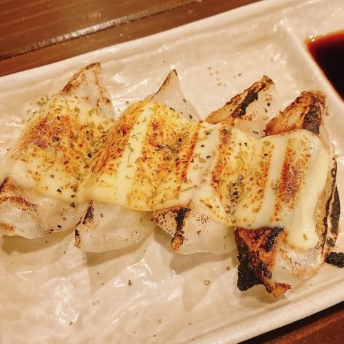 Gyoza topped with cheese