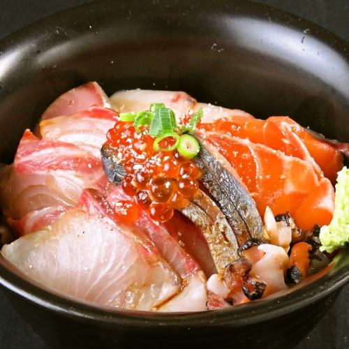 Bowl of rice topped with sashimi