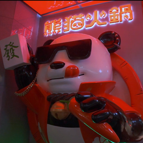 A panda will welcome you inside the stylish neon interior.