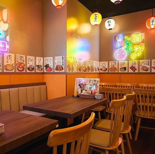 A table-seated banquet in a space lit by neon lights!