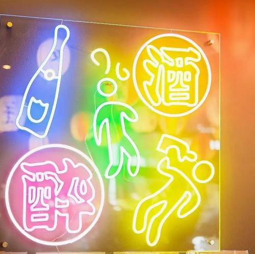 A neon-lit space shining at night in Kashiwa, toasting at a table!