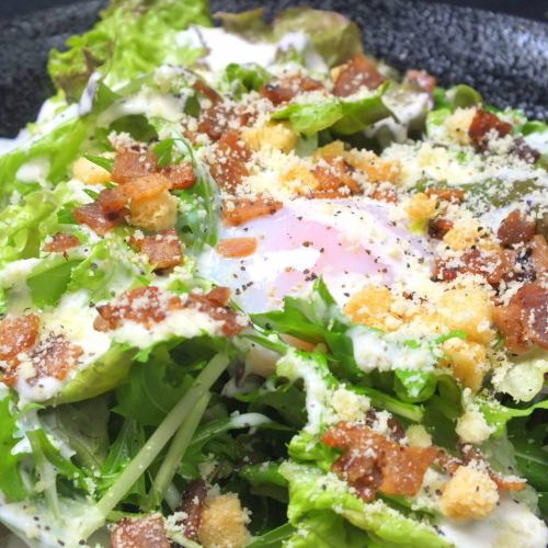 Caesar salad with hot balls and crispy bacon