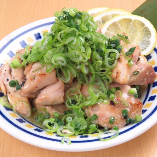 Grilled chicken covered in green onions