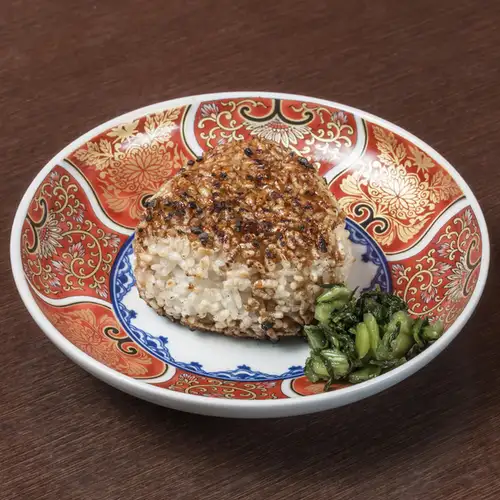 Grilled rice ball with secret sauce, featuring a raw egg/grated yam.