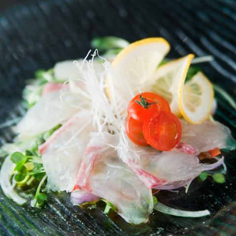 Fresh fish carpaccio with salad