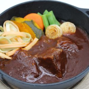 Simmered beef stew in an iron pot