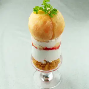 A luxurious parfait with a whole peach