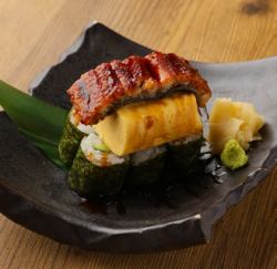 Topping sushi with eel and egg