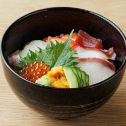 Bowl of rice topped with sashimi