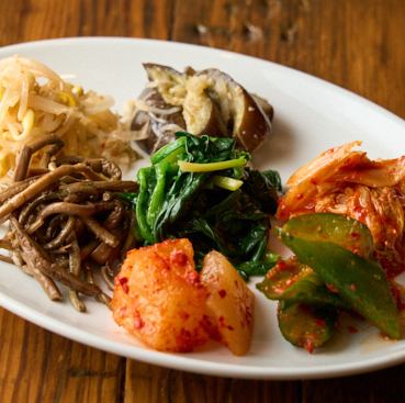 A platter of 7 kinds of kimchi and namul
