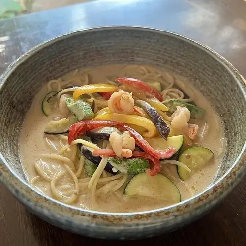 Thai-style green curry pasta with summer vegetables and shrimp