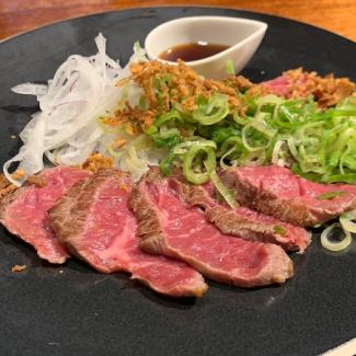 Seared wagyu beef covered in green onions