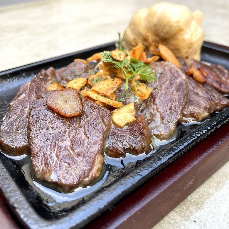 Garlic-lover's butter skirt steak on a hot plate