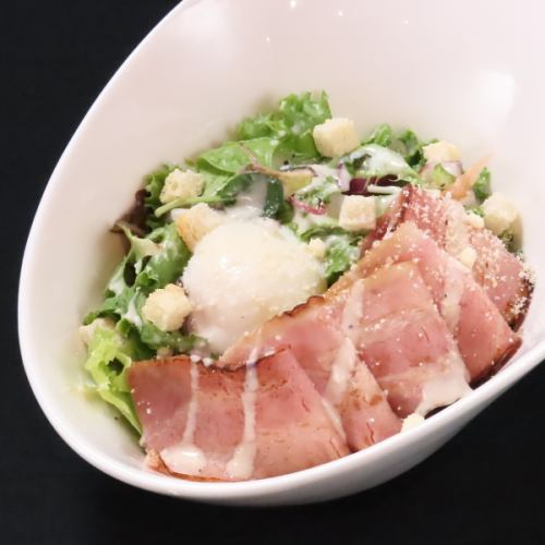 Caesar salad with grilled bacon and warm eggs