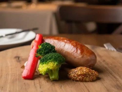 Italian artisan-made salsiccia served with colorful seasonal vegetables