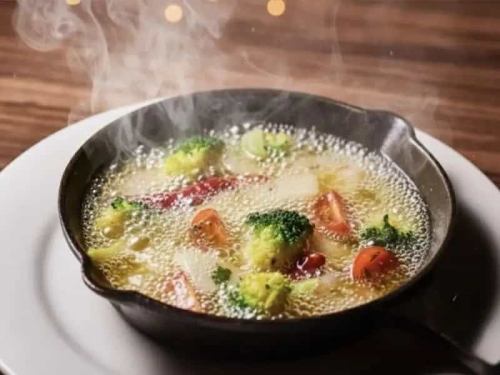 Hot seafood and seasonal vegetables ajillo with fragrant olive oil