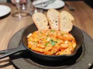 Tuscan-style tripe and white beans stewed in rich tomato sauce
