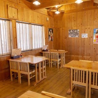 Open table seats with wood grain and high ceiling.