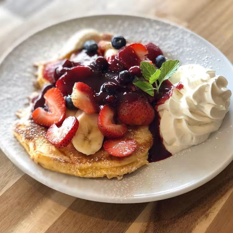 Fresh fruit pancakes with strawberries and bananas