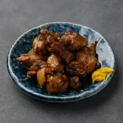 Grilled chicken thigh marinated in sauce over charcoal