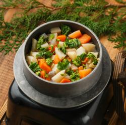 Rice cooked in a pot with local chicken and mixed vegetables