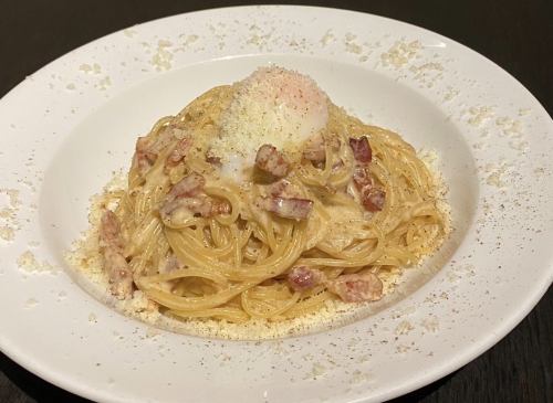 Rich carbonara with soft-boiled egg and parmesan cheese