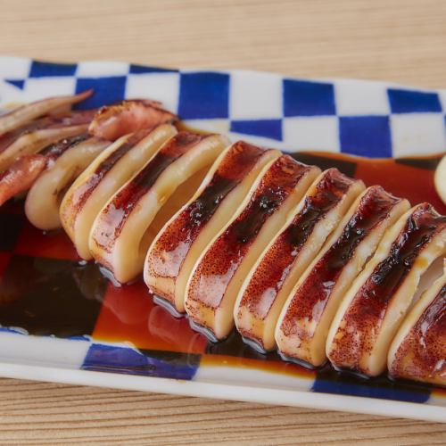 Grilled whole squid with sauce from a food stall