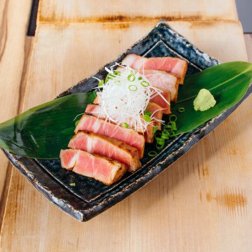 Homemade extra thick roasted pork slices grilled over straw