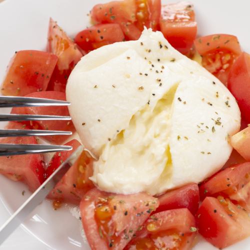 Caprese of burrata cheese and organic tomatoes