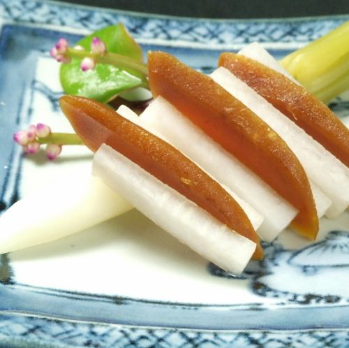 Green radish sandwiched with homemade ink