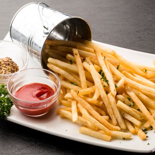 Potato fries overflowing from a bucket