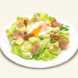 Caesar salad topped with prosciutto and soft-boiled egg