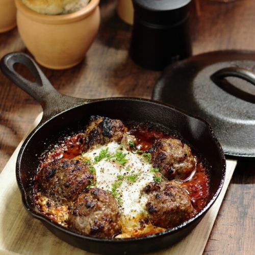 Ethnic meatballs with spiced tomato sauce and poached egg