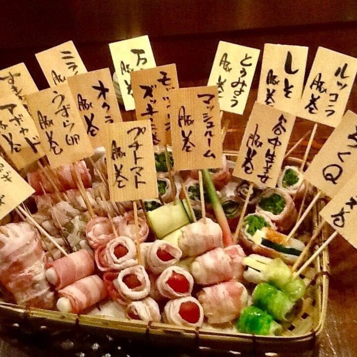A shop specializing in [vegetable roll skewers] made with seasonal vegetables wrapped in pork belly or bacon.
