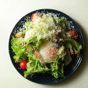 Caesar salad with soft-boiled egg and bacon