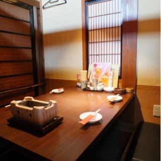 A private room with a sunken kotatsu table for four.