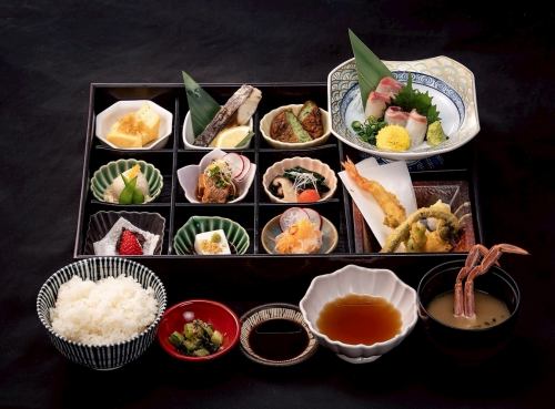 享用色彩繽紛的松戶便當盒，內含兩種魚類。