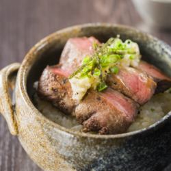 Small bowl of thickly sliced beef tongue with green onion and salt