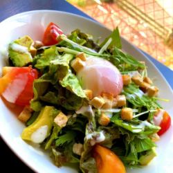 Caesar salad with soft-boiled egg and bacon
