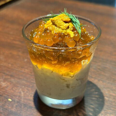 Crab tartar mousse and lobster consommé jelly topped with sea urchin and salmon roe