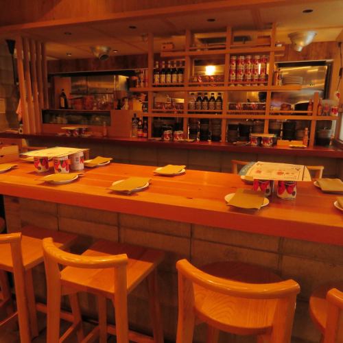 Counter seats lined with small items and wine