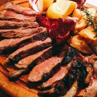 Enjoy the main dish of beef T-bone steak grilled over an open fire [BISTECCA course]