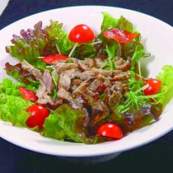 Charcoal grilled chicken skin salad