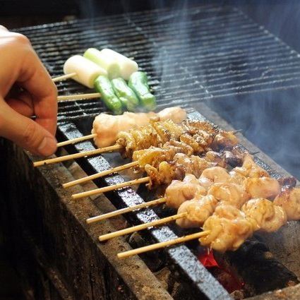 ["Specialty skewers" that are carefully grilled one by one over charcoal]