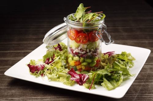 Colorful jar salad of beautiful seasonal vegetables