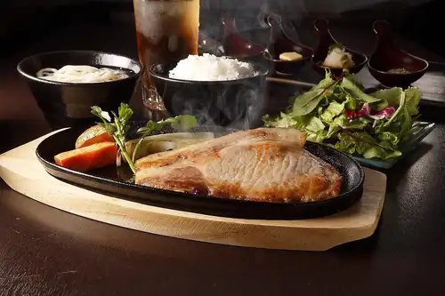 Grilled US-sourced aged lean beef steak with garlic butter sauce