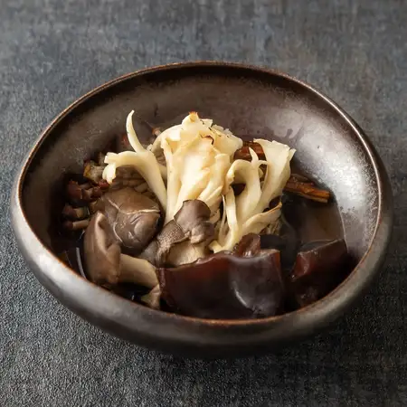 Grilled mushrooms marinated in charcoal sauce