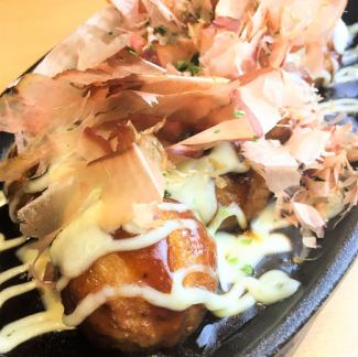 Takoyaki with cheese on an iron plate