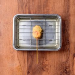 Deep-fried pork-wrapped pickled ginger skewers