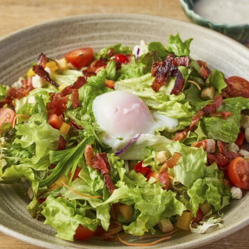 Caesar salad with soft-boiled egg and bacon